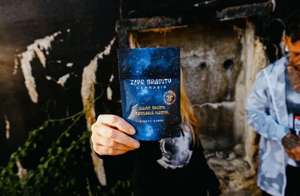 Zero Gravity Cannabis team in front of a concrete wall